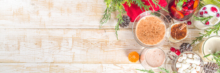Set of different Christmas and winter drinks. An assortment of Christmas cocktails, hot and cold beverages, in cozy wooden home background with Xmas decor