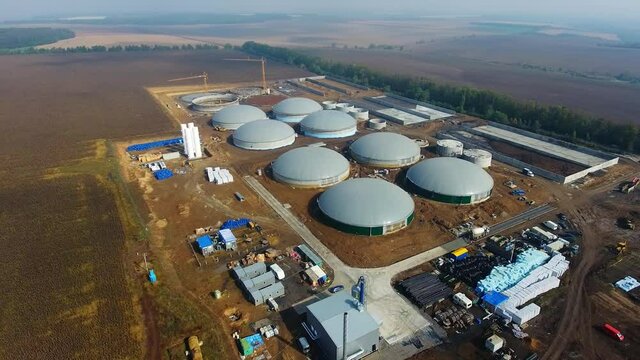 Many round roffs of bio fuel factory construction. Modern ecological production. View from above on production zone.