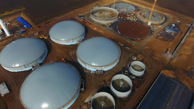 Round gray roofs of future bi gaz factory. Construction of new ecological plant.
