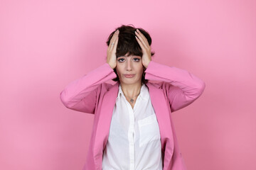 Young business woman over isolated pink background thinking looking tired and bored with hands on head