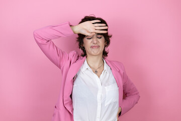 Young business woman over isolated pink background Touching forehead for illness and fever, flu and cold, virus sick
