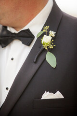black tuxedo and bow tie with boutonniere - obrazy, fototapety, plakaty