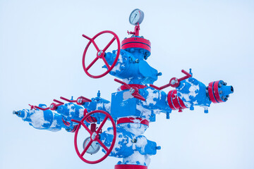 Oil, gas industry. Group wellheads and valve armature ,Gas well of high pressure; gas production process, shooting in the snow
