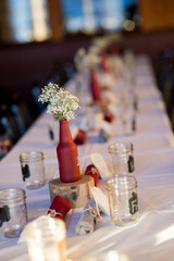 wedding reception table with painted wine bottles