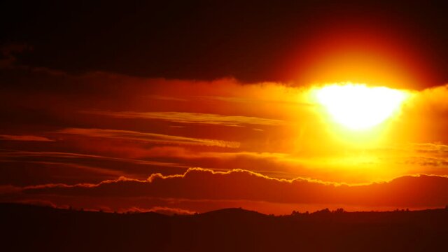 Skyscape. Burning sky, dark stormy clouds. Red orange color sunset over sea. Nature, coastal landscape. Capi Corb, Mediterranean coast of Spain.