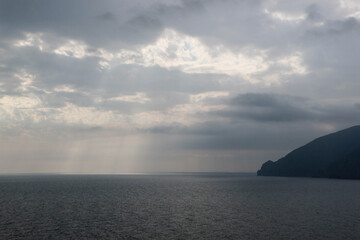 Fototapeta na wymiar sun rays shine through the stormy clouds over Black sea in Crimea