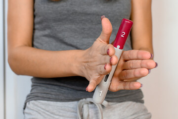 Woman holding in hands shot pen, preparing it for use.