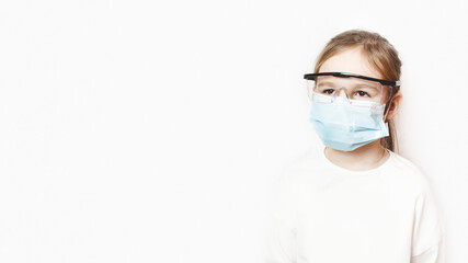 Coronavirus protection. The face of a child in a mask and glasses. A little preschool girl observes the prevention of covid 19. Children's health and viruses. Respiratory protection for babies. 