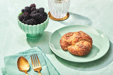 Breakfast Scene with Croissant and Blackberries on Green Marble