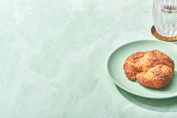 Croissant and Glass Isolated on Green Marble