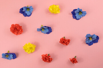 Assorted multicolored decorative flowers on a pink background, pattern, flat lay design, floral