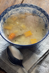 Hot vegetable soup in a deep blue plate