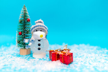 snowman with protective mask presents and Christmas tree snow with copy space.new year celebration.