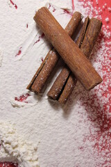 Three cinnamon sticks lie on a white-colored background cooking a penny a copy of the space