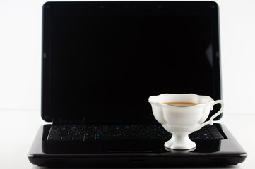 mug of coffee on the laptop keyboard