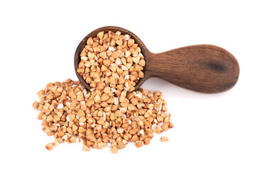 Buckwheat groats in wooden spoon, isolated on white background. Green buckwheat seeds.
