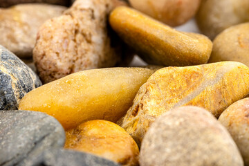 A macro shot of decorative colored pebbles, shallow depth of field, for use on a background.