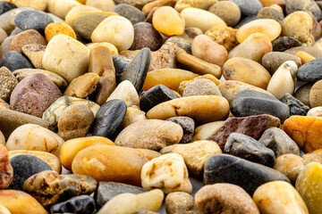 A macro shot of decorative colored pebbles, shallow depth of field, for use on a background.