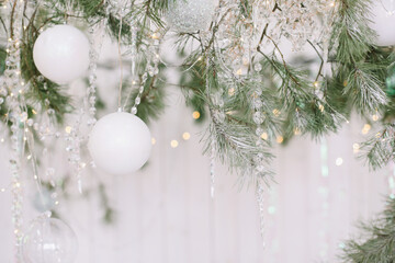 Fototapeta na wymiar Christmas decor on a white background. Christmas tree branches with toys. Space for text