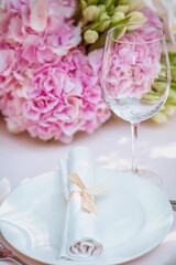 flowers and glass, plate, fork, knife on the table. Cutlery, food, lunch, party concept