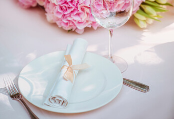 flowers and glass, plate, fork, knife on the table. Cutlery, food, lunch, party concept