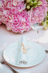 Fototapeta na wymiar flowers and glass, plate, fork, knife on the table. Cutlery, food, lunch, party concept