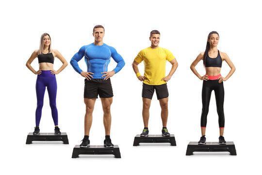 Full length portrait of men and women standing on step aerobic platforms