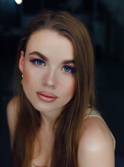 Close up portrait of beautiful woman professional trendy makeup with cobalt blue color eyelashes by artist with ring light reflection in model eyes