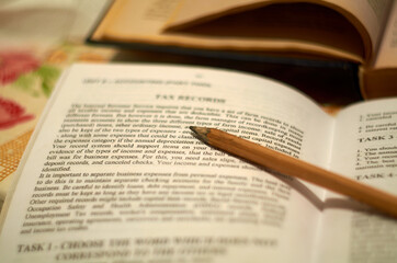 Open economics textbook and pencil