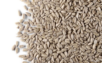 Peeled sunflower seeds isolated on white background and texture, top view