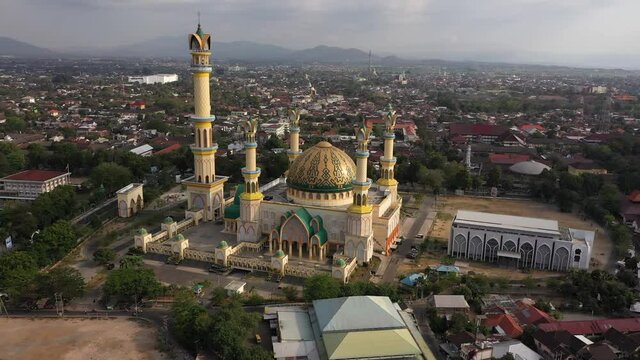 Beautiful Exterior Of Islamic Center Mosque In Mataram, Lombok, Indonesia With Colorful Dome And Tall Minaret - aerial drone