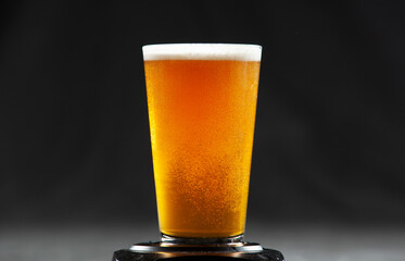 glass of beer with fresh carbonation 