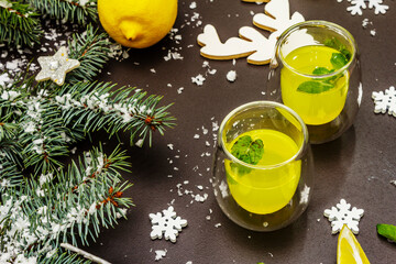 Low alcoholic cocktail limoncello with Christmas decoration, fresh citrus and mint