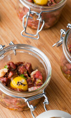 Steak tartare. Classic American restaurant or French bistro appetizer classic. Steak diced, mixed with eggs, red onions, olive oil, lemon juice, garlic and capers. Served with garlic bread.