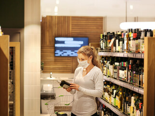 supermarket shopping, face mask,Woman choosing a dairy products at supermarket.