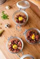 Steak tartare. Classic American restaurant or French bistro appetizer classic. Steak diced, mixed with eggs, red onions, olive oil, lemon juice, garlic and capers. Served with garlic bread.