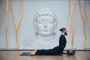 Young Woman Doing Yoga Exercise in Studio.