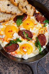 Eggs and chorizo frittata or omelette. Chorizo, salt, pepper, scallions, parsley, cheese with parsley and avocado slices. Classic American, French or Italian restaurant breakfast or brunch favorite.