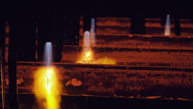 Steel industry: gas cutting of metal pipes. Modern robotic tools in heavy industry, ferrous metallurgy. High precision manufacture of steel parts. Automation of process indoors factory.