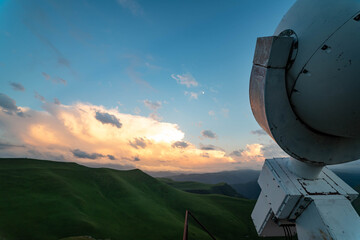 Fototapeta na wymiar Soft sunrise in the mountains and telescope