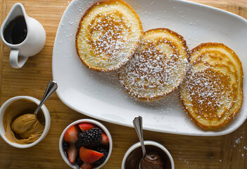 Pancakes. Homemade Pancakes with crispy Bacon, butter and maple syrup. Classic American breakfast or brunch favorite. Made from scratch Cakes with bacon, butter and maple syrup.