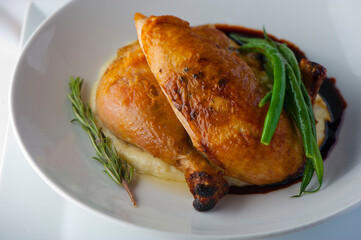Chicken pan seared in garlic, butter, shallots and white wine. Classic fine dining cuisine. Served with steamed vegetables, broccoli carrots cauliflower, garnished with lemons and Italian parsley.
