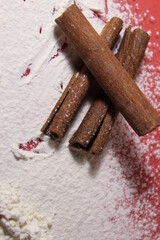 Three cinnamon sticks lie on a white-colored background cooking a penny a copy of the space