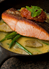Salmon steaks. Salmon sautéed in organic butter, garlic and served with jumbo lump crab cake, cauliflower, broccoli and potatoes. Classic American restaurant or French bistro entree favorite.