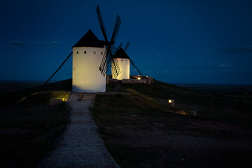 Exterior view of windmills in the landscape in spring at night in the Alcazar de San Juan, Ciudad Real, Spain