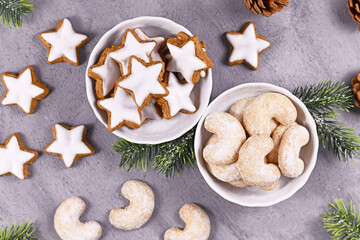 Bowls with traditional German and Austrian Christmas cookies, one filled with cinnamon star cookies, the other with crecent shaped almond cookies