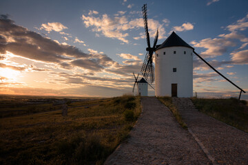 Exterior view of windmills on landscape in spring at sunset in Alcazar de San Juan, Ciudad Real, Spain