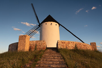 Exterior view of windmills on landscape in spring at sunset in Alcazar de San Juan, Ciudad Real,...