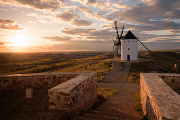 Exterior view of windmills on landscape in spring at sunset in Alcazar de San Juan, Ciudad Real, Spain