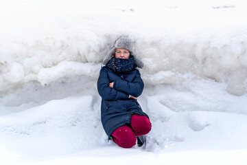 Fototapeta na wymiar Woman on the background of a winter landscape with large hummocks, frozen ice, Jurmala, Latvia. Winter walk.